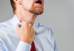 Man itching around his collar