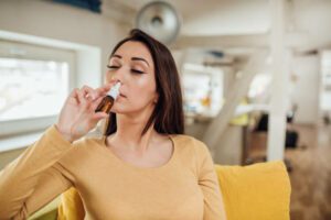 Young woman taking her sinus medicine