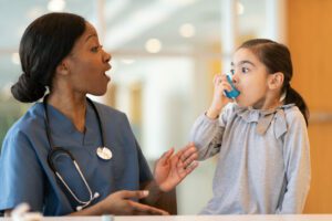 allergy doctor assists child asthmatic patien