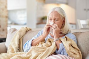 senior lady suffering with seasonal allergies